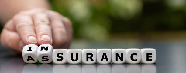 istock Hand turns dice and changes the word assurance to insurance. 1256371169