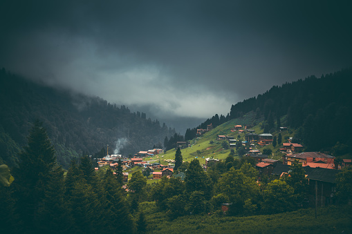 Landscape of beautiful sunrise view with storm and rainy weather from the Ayder highland with traditional wooden houses in Pokut, Çamlıhemşin, Rize in Karadeniz region of Turkey