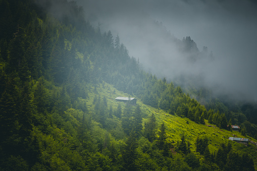 Landscape of beautiful foggy view with storm and rainy weather from the Hüser highland with traditional wooden houses in Pokut, Çamlıhemşin, Rize in Karadeniz region of Turkey