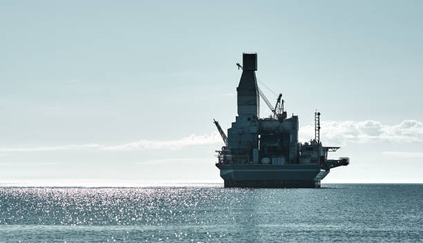 istock Offshore platform and support vessel offshore area, sea wave and cloudy blue sky 1256373556