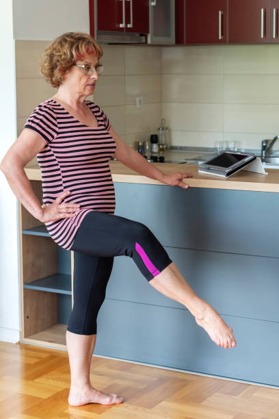 istock Senior woman exercise at home 1256376945
