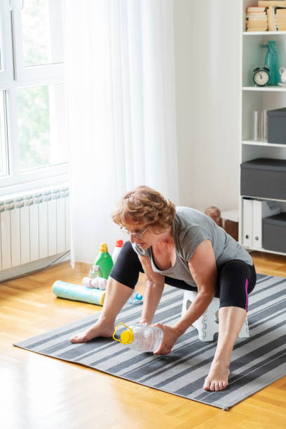istock Senior woman exercise at home 1256376949