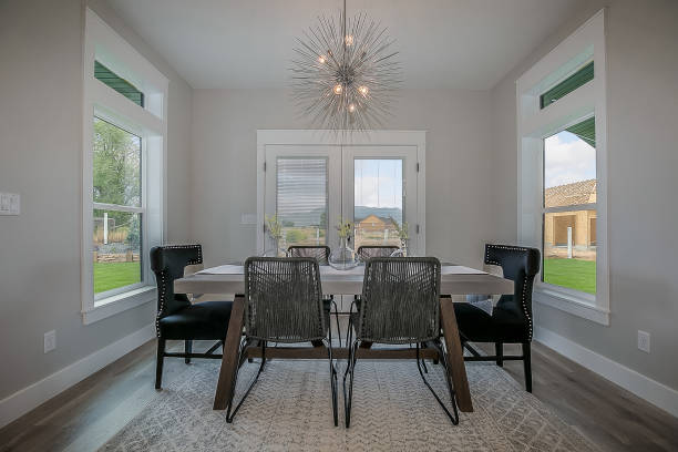 istock Simple dining area with unique light fixture 1256377235