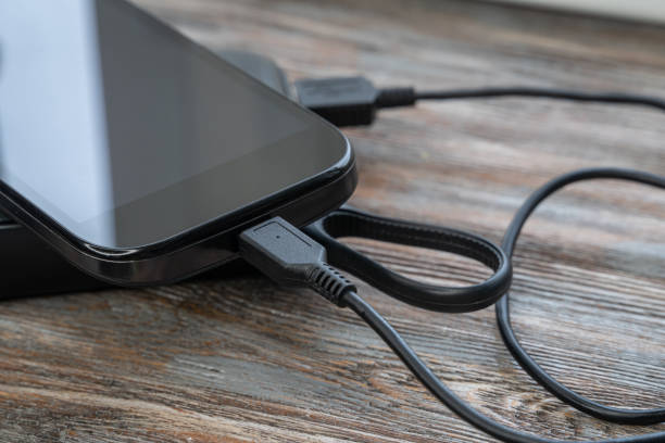 istock Phone and charging devices with energy power or storage and charging cable 1256378132