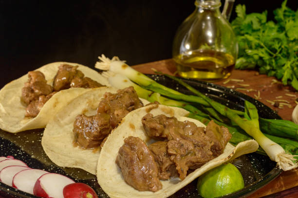 istock Mexican will snatch tacos with sides and herbs, low key with copy space 1256378169