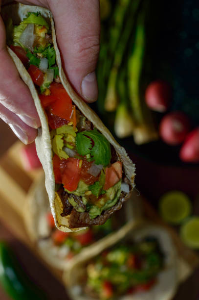 istock Mexico tacos, lifting grilled carne asada 1256378358