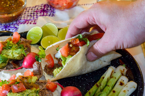 istock Picking up carne asada tacos to eat 1256378459