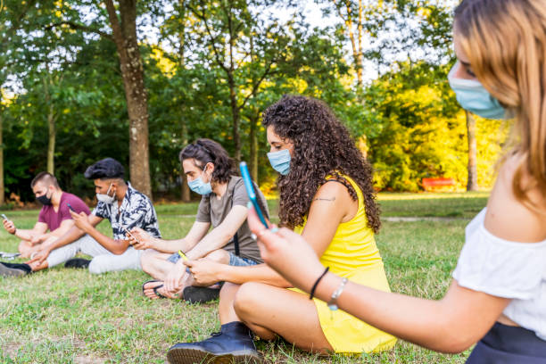 istock group of multiracial friends sitting 1256379106