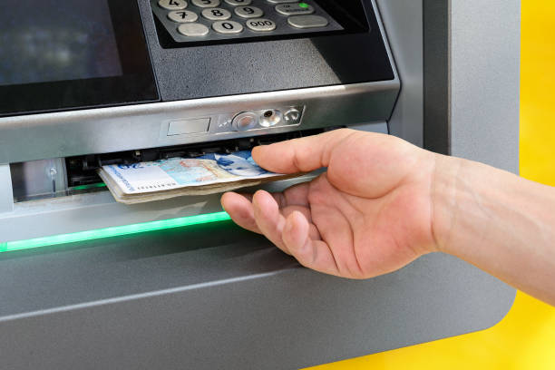 Caucasian man hand taking bulgarian levs from ATM. Receive money at a cash machine outdoors. ATM cash withdrawal. stock photo
