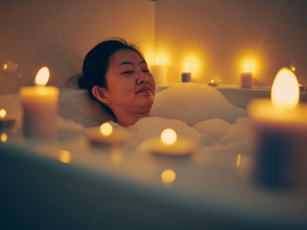 istock Japanese Woman Taking a Candlelight Bath 1256383155