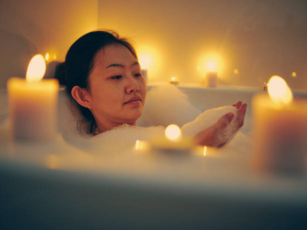 istock Japanese Woman Taking a Candlelight Bath 1256383234