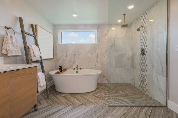 istock Freestanding bathtub sits right next to open shower and beautiful chevron patterned flooring 1256384397