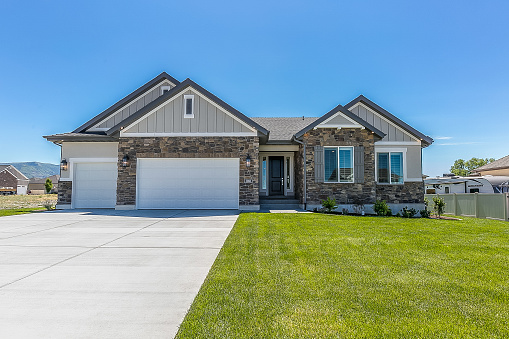 Three car garage of single story home on a sunny day