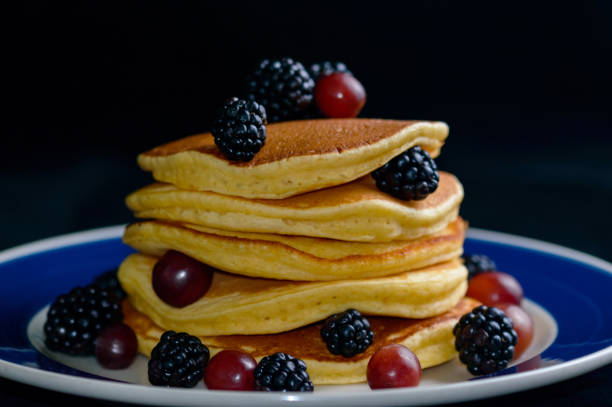 istock Stacked pancakes with summer fruits 1256386180