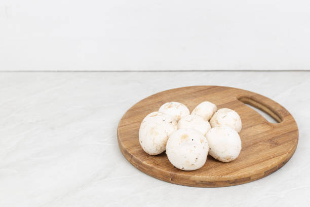 istock Mushrooms on the wooden cutting board with copy space 1256386258
