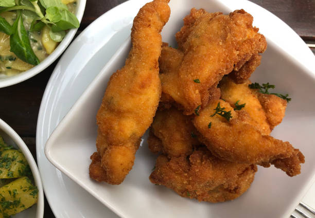 istock Breaded fried chicken with parsley potatoes and potato salad. 1256386411