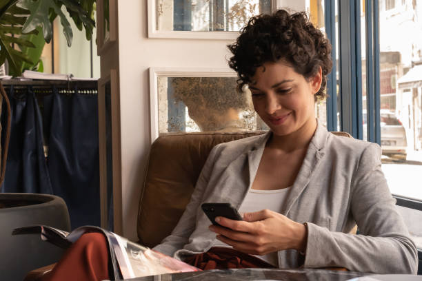 A beautiful woman using her smartphone indoors.