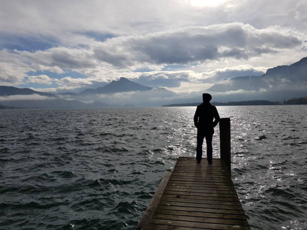 istock Walking Alone lake wolfgangsee Saint gilgen Austria 1256388794