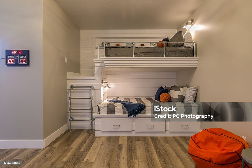 Kids basketball themed bedroom Scoreboard and basketball bean bag are cool additions to this bedroom with built in bunkbeds Bunkbed Stock Photo