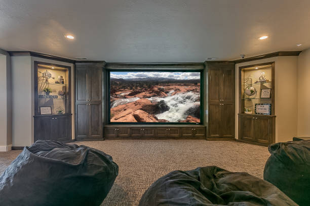Spacious yet cozy theater room Bean bags and lounge chairs along with snacks make for a perfect viewing party surround sound stock pictures, royalty-free photos & images