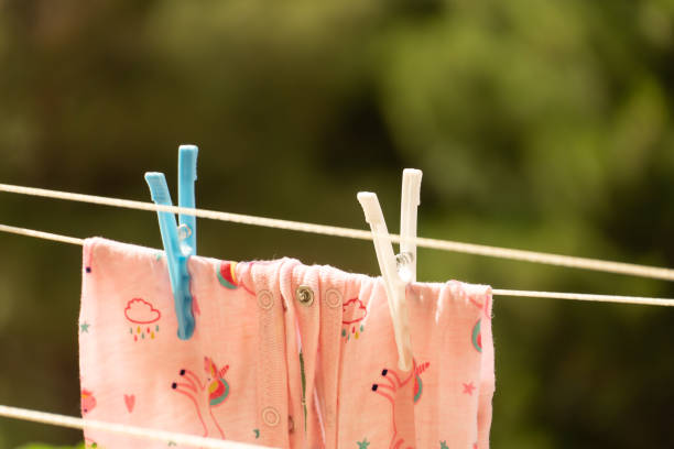 istock children's clothes hanging on clothesline with pegs 1256388986