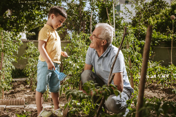 istock Grandfather and grandson work in the garden 1256390708