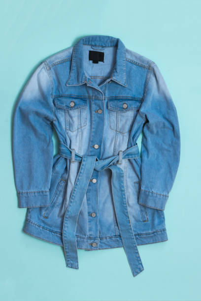 istock Women's denim coat on a blue background. 1256395173