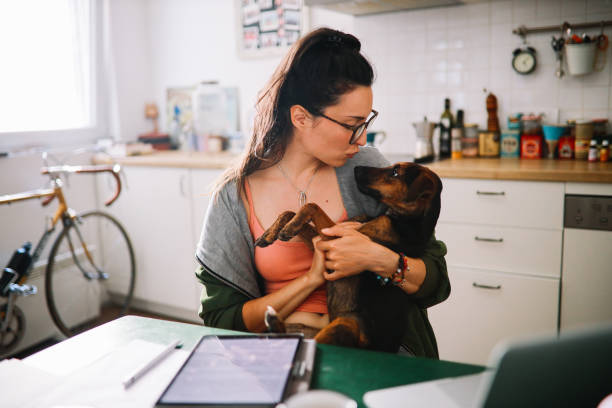 istock working from home with her pet dog 1256395215