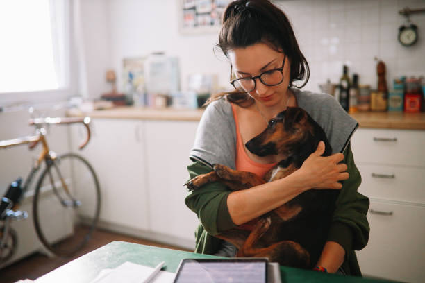 istock working from home with her pet dog 1256395264