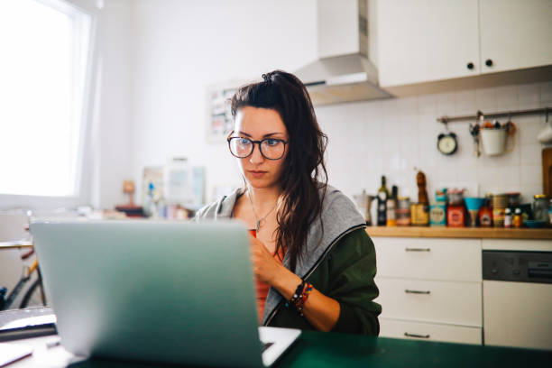 istock young woman having coffee while working from home 1256396008