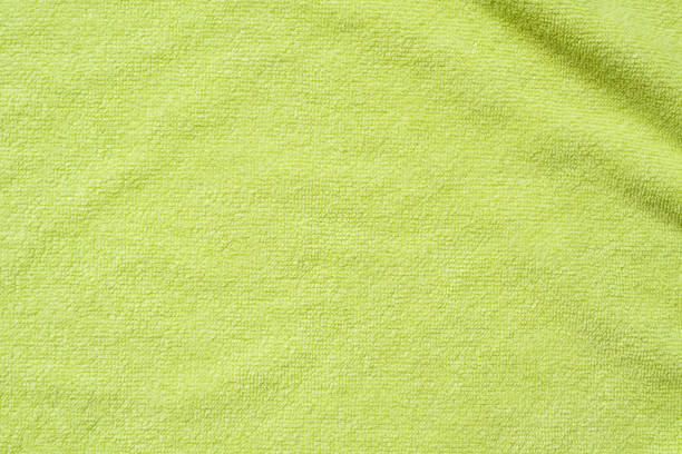 istock Green towel fabric texture surface close up background 1256397382