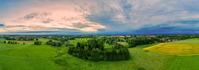 Beautiful panoramic aerial view over a countryside sunrise with fields and trees in southern germany.