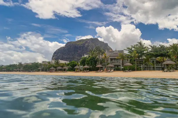 Paradise view at Mauritius. View from the ocean water to the popular rock called Le Morne Brabant with sandy beach at a warm summer day.