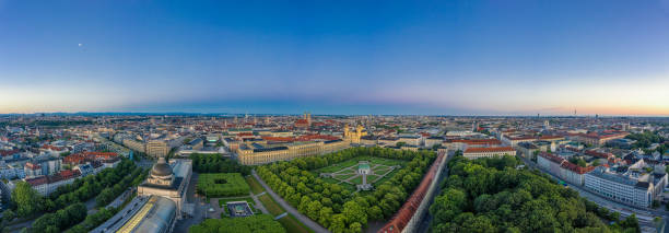 Beautiful aerial view over the bavarian metropole city Munich with the alps mouintains in the background. Total panoramic view over the authentic cityscape. Beautiful aerial view over the bavarian metropole city Munich at sunrise munich cathedral photos stock pictures, royalty-free photos & images