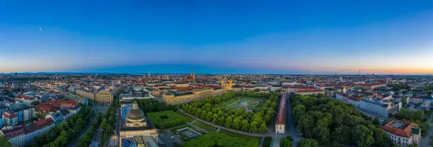 Photo of Aerial, morning view over the bavarian capital Munich, germany with houses, offices and a green park. Aerial, authentic droneshot in panoramic view.