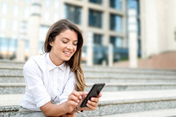 istock Happy young working woman using phone. 1256403959