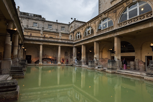Bath , UK - Aug 1, 2017:  People visiting the Roman Baths  late in the day.