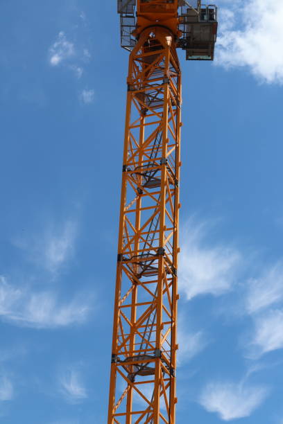 istock Yellow crane tower against a blue sky 1256404167