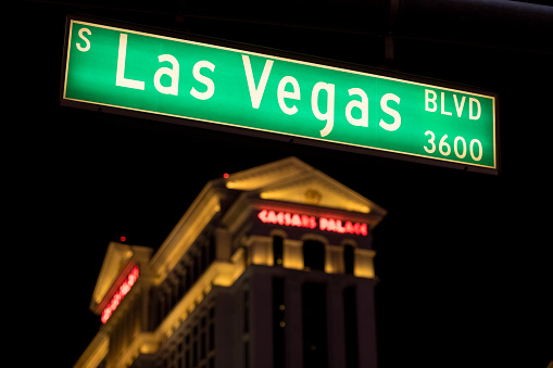 Las Vegas, USA - Sep 22, 2019: A Las Vegas blvd street sign early in the evening with the Caesars hotel in the background.