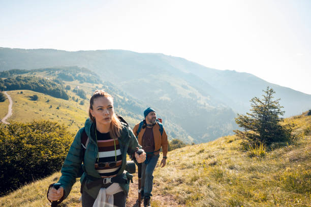 istock Young couple hiking in the mountains 1256404724