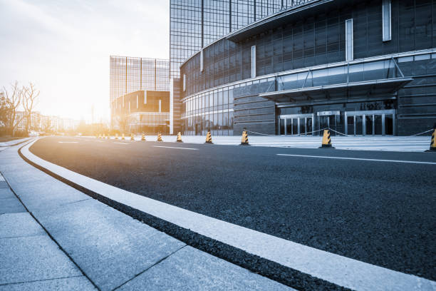 istock empty asphalt road front of modern buildings 1256404804