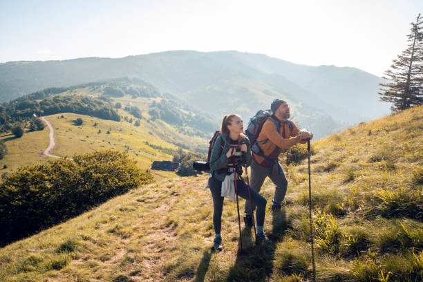 istock Young couple hiking in the mountains 1256405595