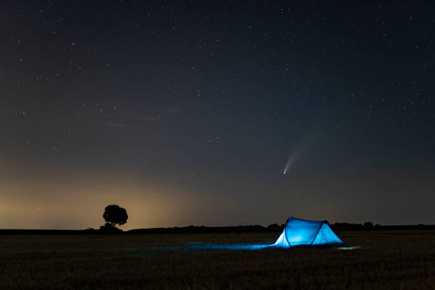 istock C / 2020 F3 comet (NEOWISE) in the evening sky. Camping under the starry sky, where there is a bright comet and a tail between the stars. Photographed in Hungary on July 14, 2020. 1256406564