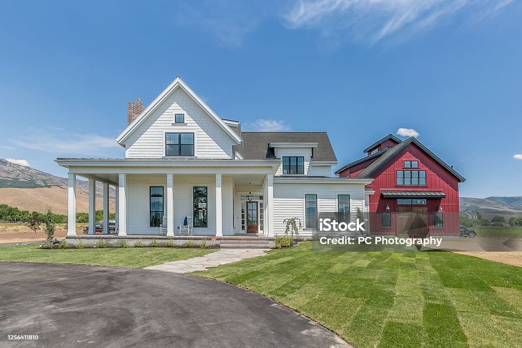 Gorgeous New England style modern farmhouse Stately new home with attached red barn which is actually a separate mother-in-law living space Modern Farmhouse Stock Photo