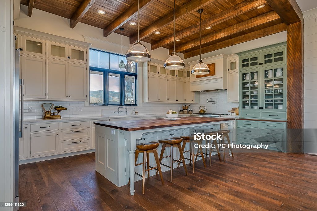 Awe-inspiring kitchen and open layout modern New England style farmhouse Natural wood flooring and ceiling add realness to custom-built home Kitchen Stock Photo