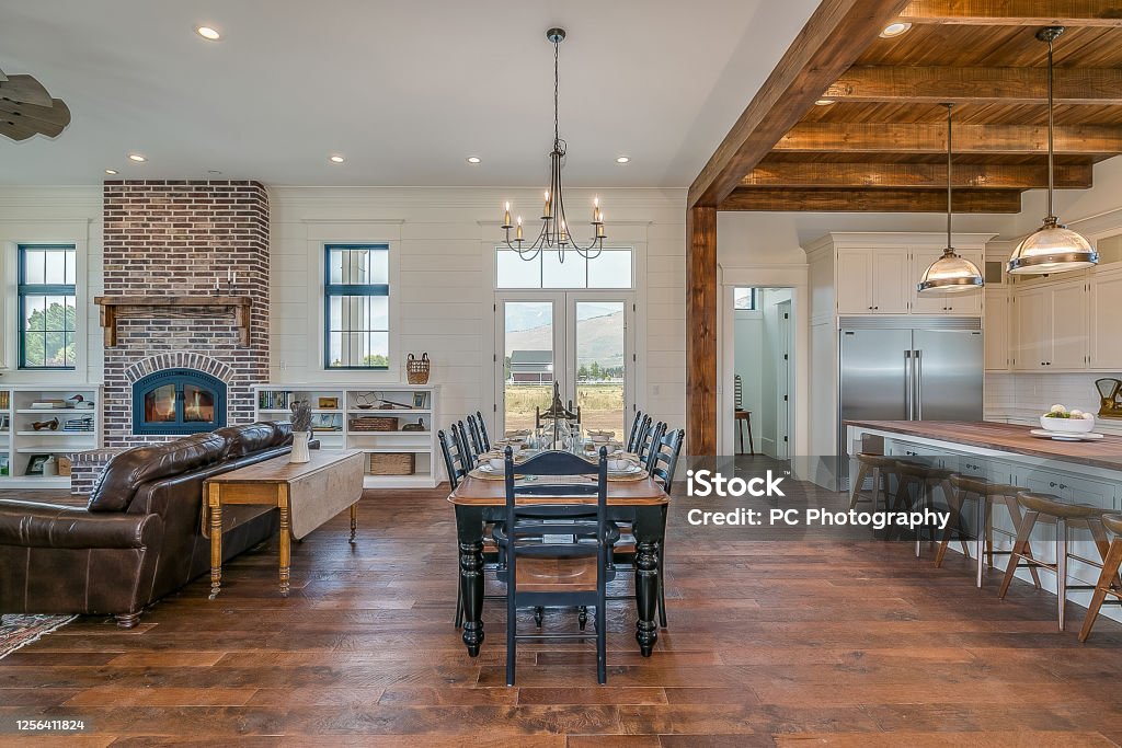 Awe-inspiring kitchen and open layout modern New England style farmhouse Natural wood flooring and ceiling add realness to custom-built home Hardwood Floor Stock Photo