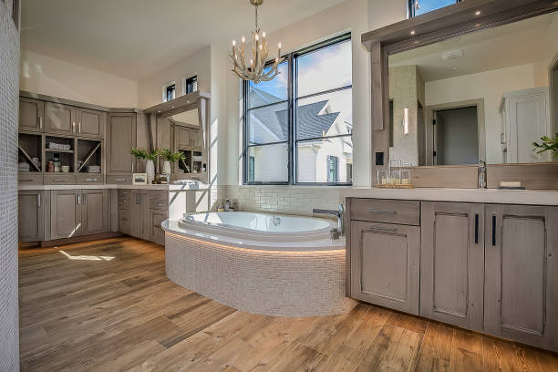 Old style bathroom interior  with white cabinets, bath tub, toilet and nice green curtain on the window. Northwest, USA