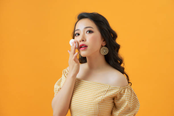 portrait of beautiful asian woman applying powder puff at cheek makeup of cosmetic, beauty of girl with face smile isolated - powder puff imagens e fotografias de stock