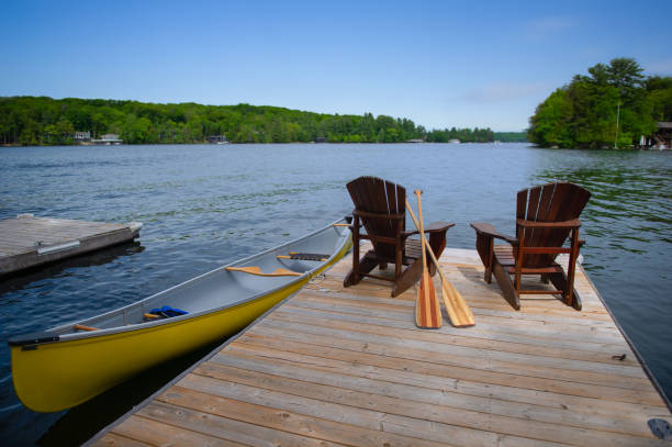 istock Two Adirondack chairs on a wooden pier 1256422159