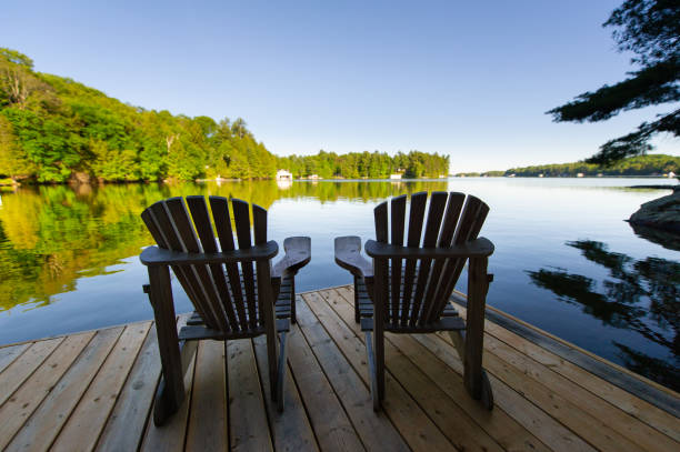 istock Two Adirondack chairs sitting on a wooden pier 1256422176